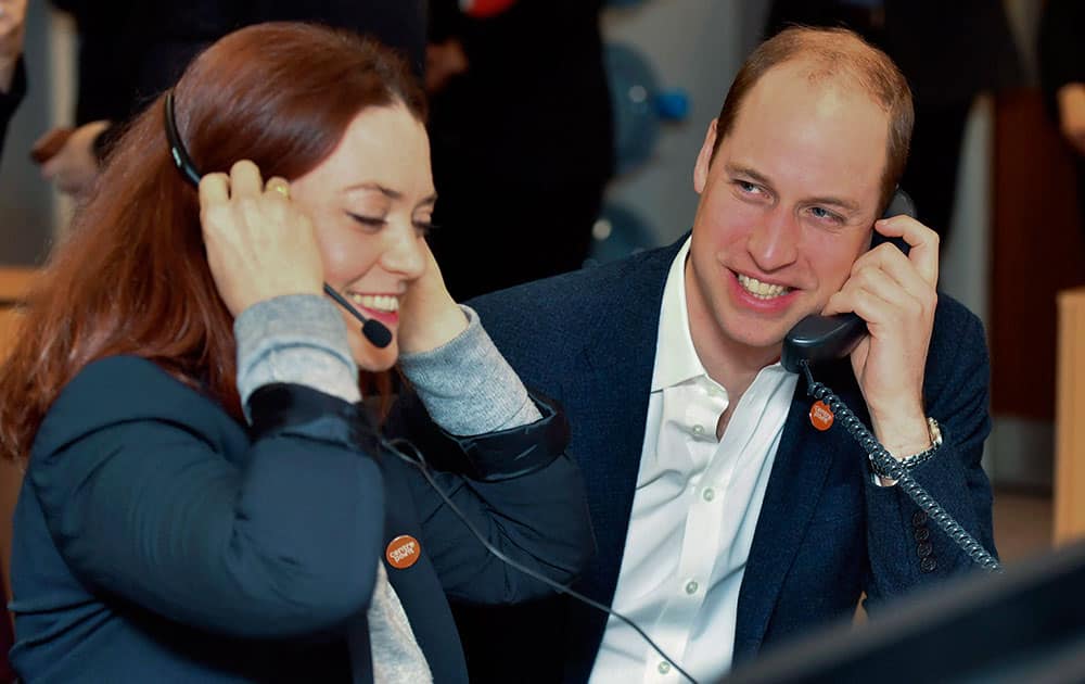 Prince William, the Duke of Cambridge talks on the phone as he officially launches the Centrepoint Helpline