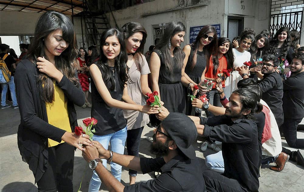 Boys give roses to girls on Valentines Day in Surat