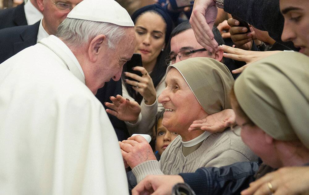 Pope Francis stops to greet a nun