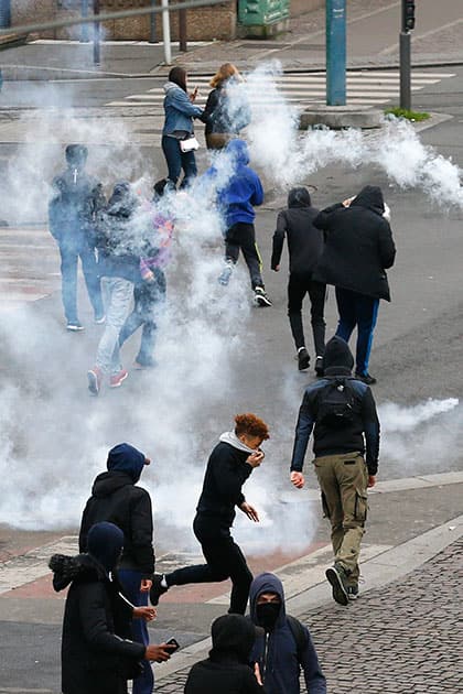 Youth run away fromtear gas during a protest