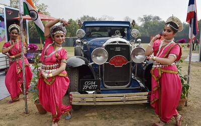 Folk artists pose in front of Vintage Car during the 21 Gun Salute Vintage Car Rally & Concours Show 2017