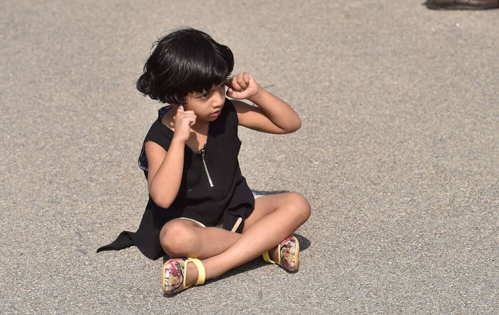 Child shields ear in Bengaluru Child shields ear in Bengaluru