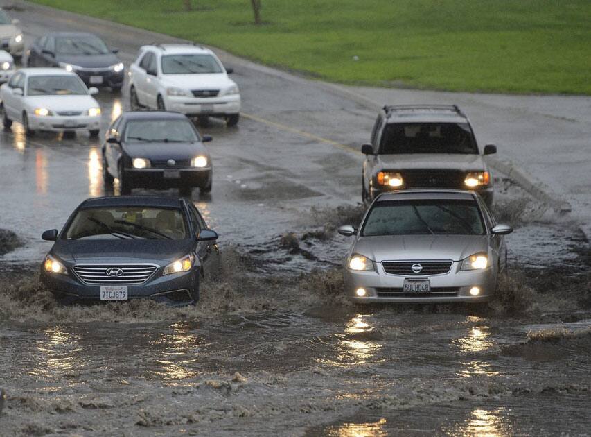Cars navigate flooding Cars navigate flooding