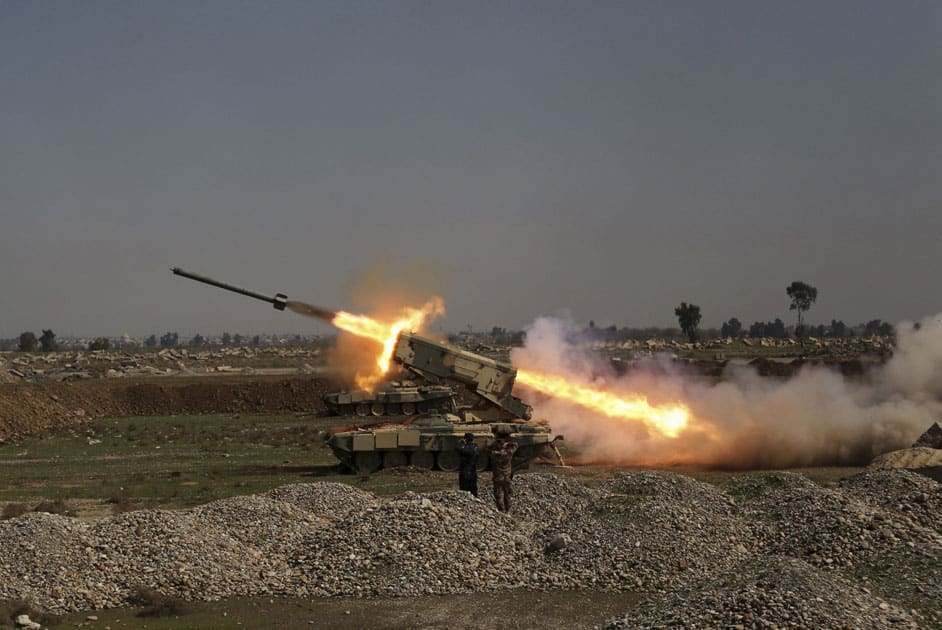 Iraqi security forces launch a rocket