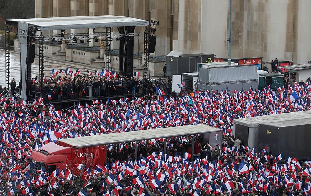 Supporters listen to conservative presidential candidate Francois Fillon during a rally in Paris