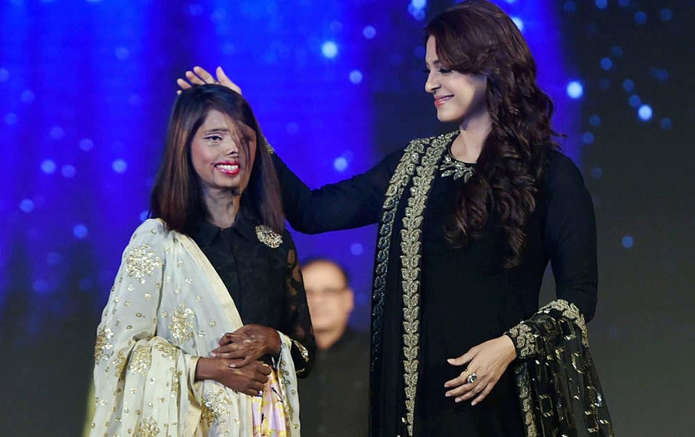 Juhi Chawla, walks on ramp with an acid attack victim