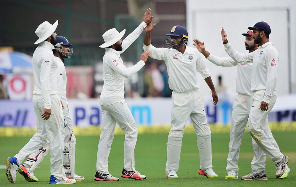 Indian players celebrate the wicket of Australias Mitchell Starc