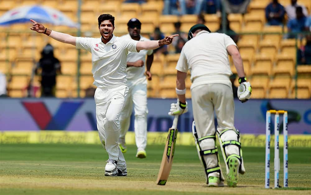 Umesh Yadav celebrates the wicket of Steve Smith