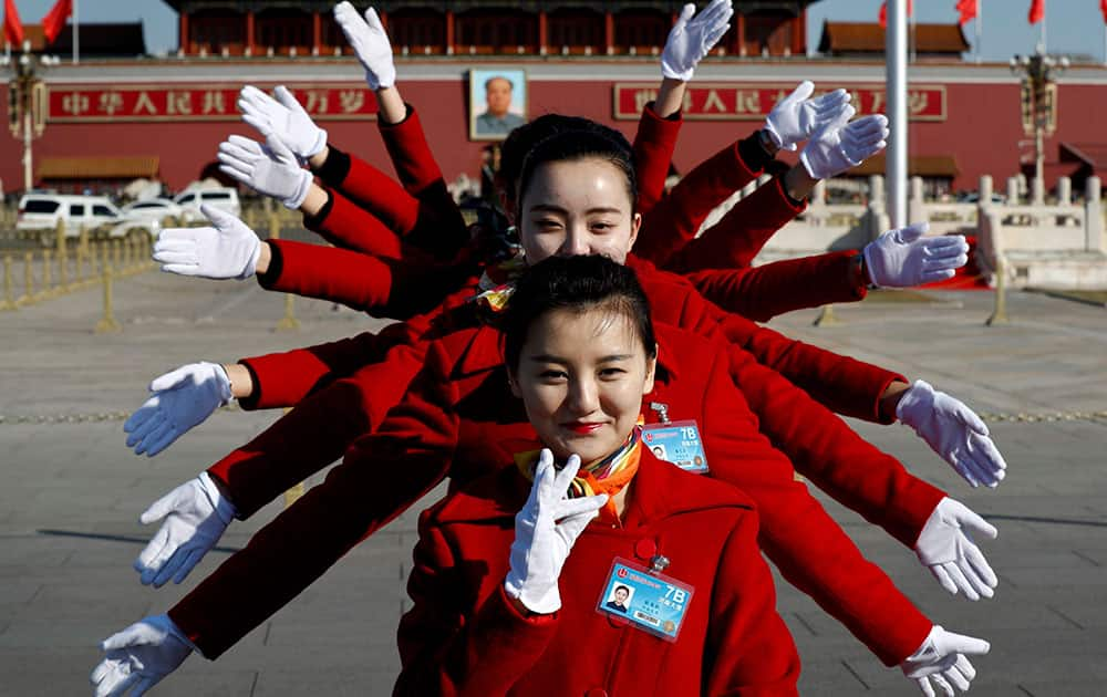 Hospitality staff pose for photos on Tiananmen Square