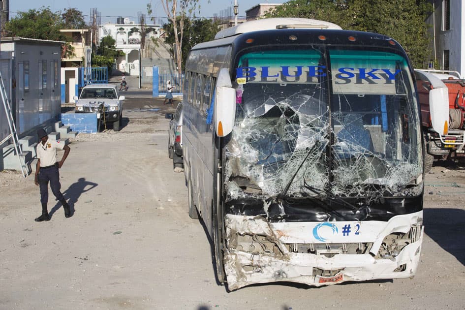 A police officer walks past a bus