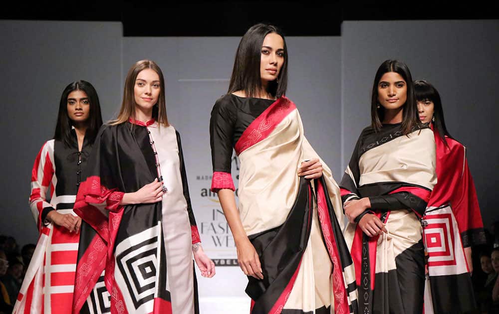 Models walk the ramp during India Fashion Week