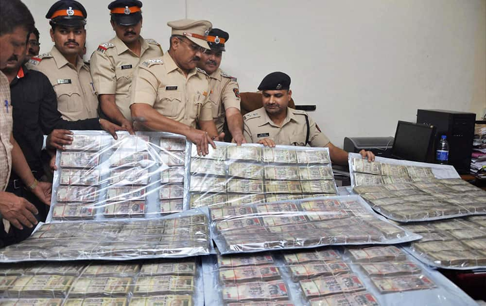 Police shows seized currency notes