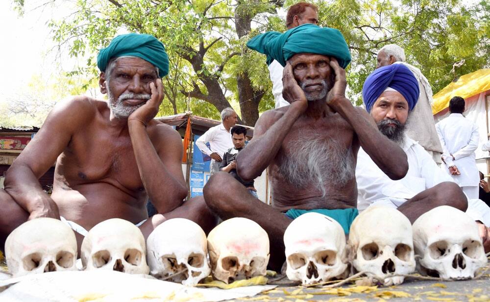 Farmers holding human skull Farmers holding human skull