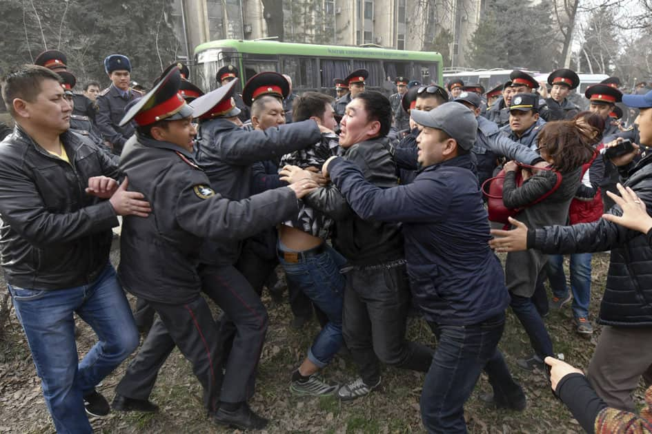 police officers detain demonstrators