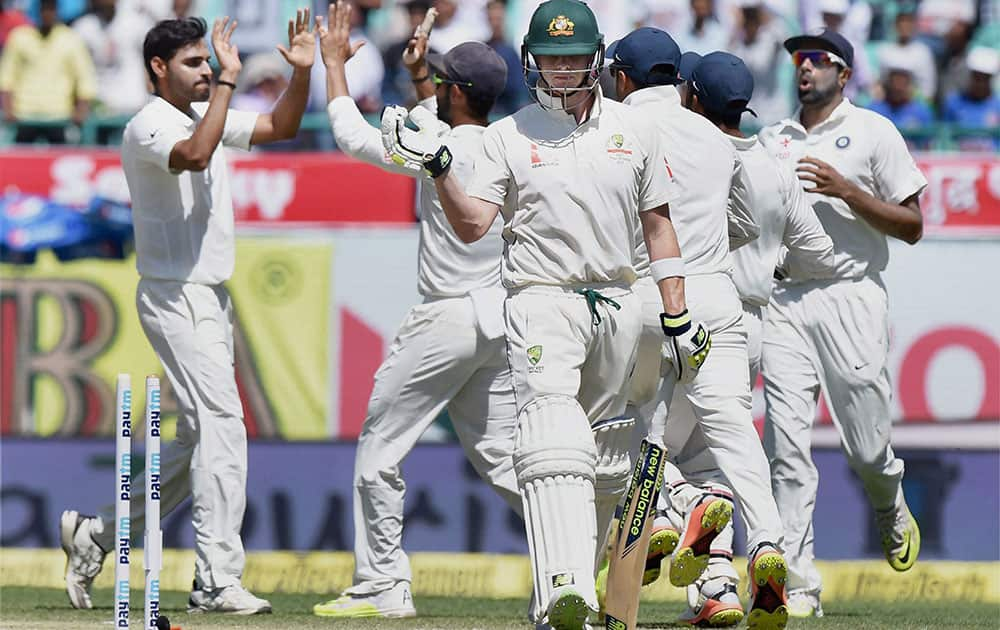 Bhuvneshwar Kumar celebrates the wicket of Steve Smith during the 3rd day of last test match at HPCA Stadium in Dharamsala