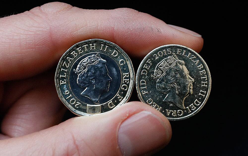 A new 12-sided Â£1 coin is displayed in London