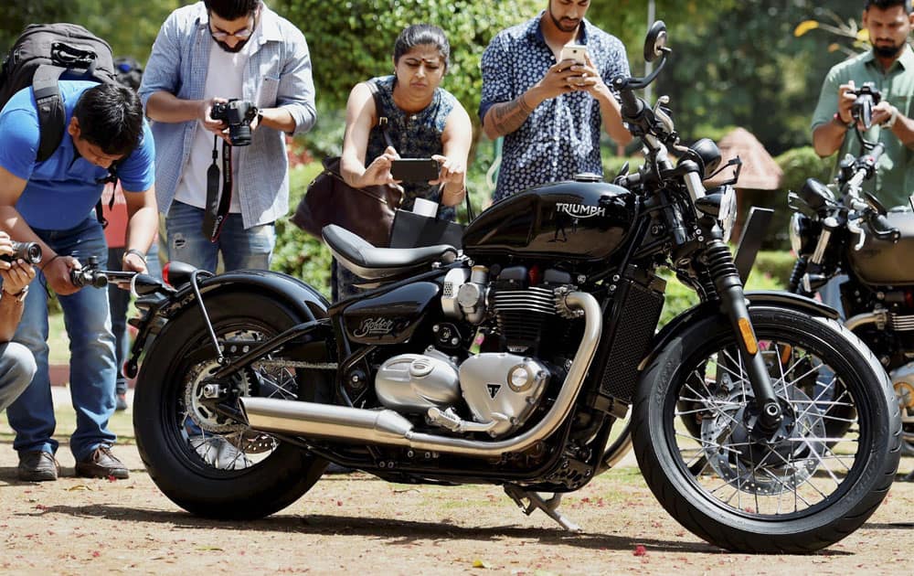 Youngsters click pictures of the Triumph Bonneville Bobber at its launch