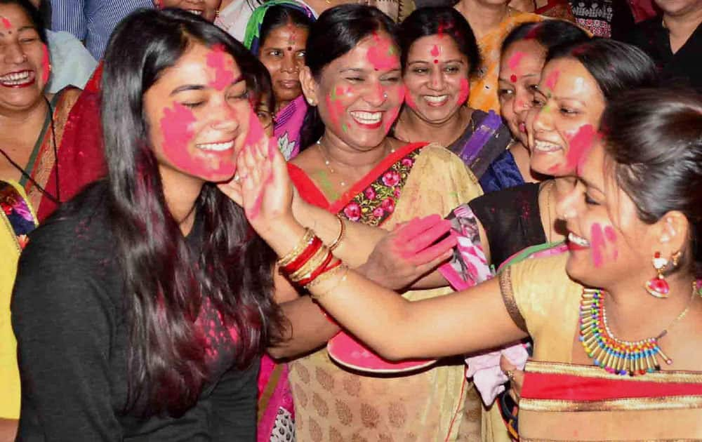 Women play with colours to celebrate the Hindu New Year 