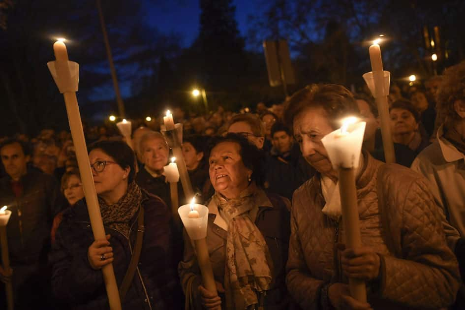 Devotees hold candles