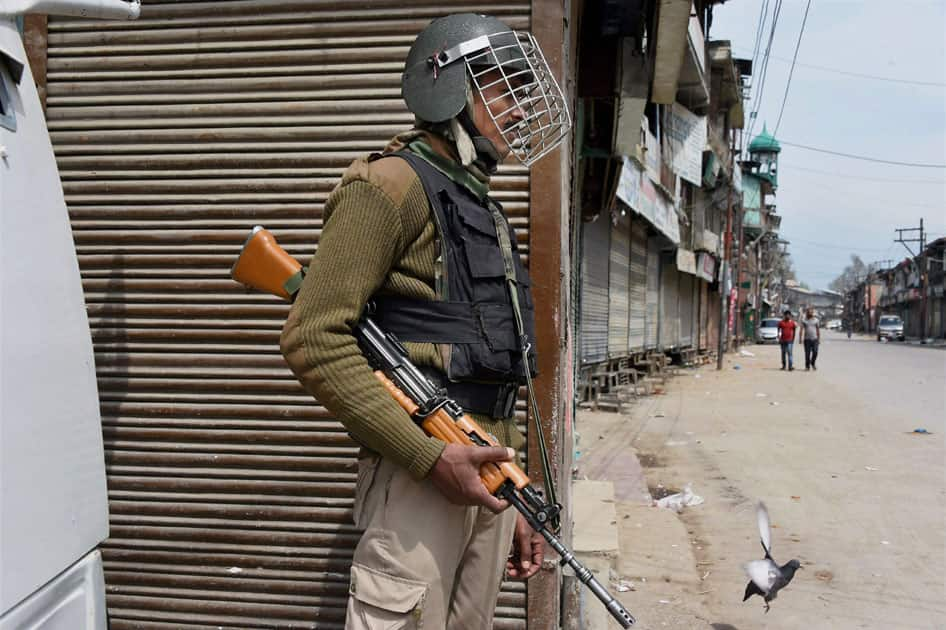 Security jawan guarding street in J&K