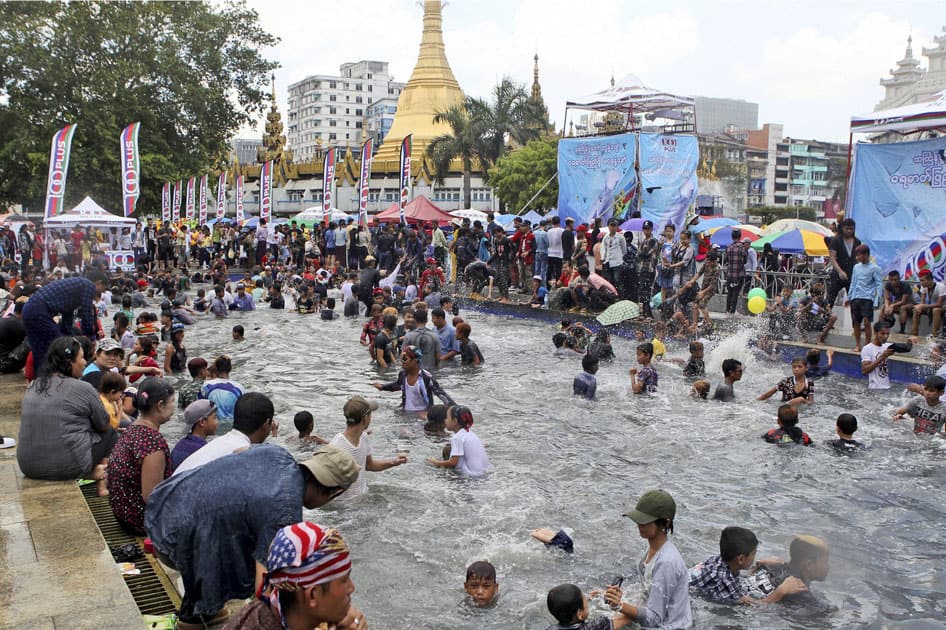 Revelers swim in a pool