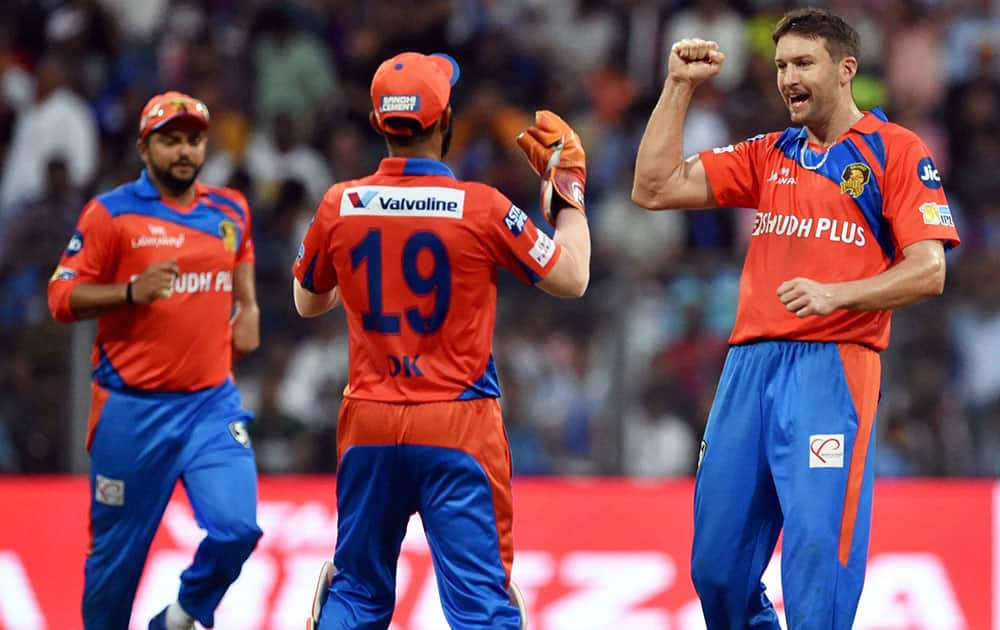 Gujarat Lions players celebrate wicket of Nitish Rana during the IPL match