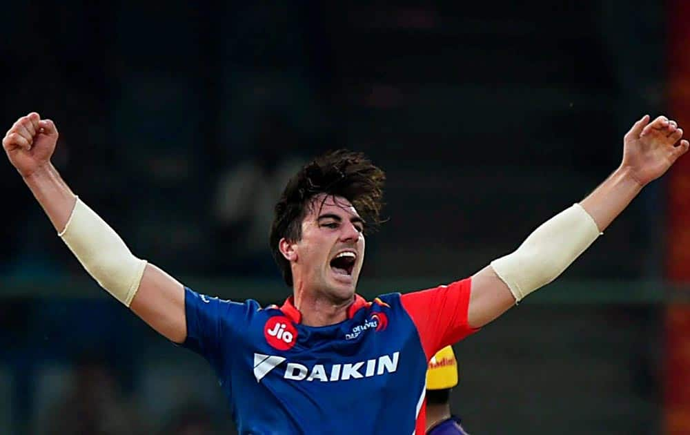 Delhi Daredevils player Patrick Cummins celebrates the dismissal of KKRs Robin Uthappa