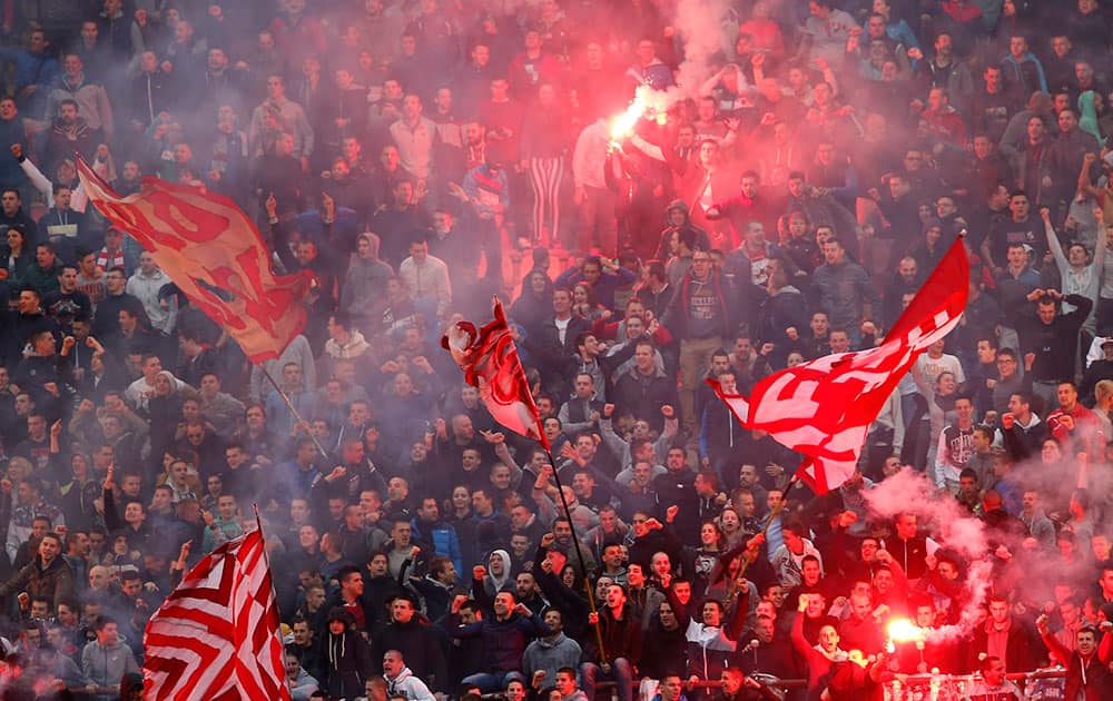 Red Star soccer fans light torches during a Serbian National soccer league derby match 