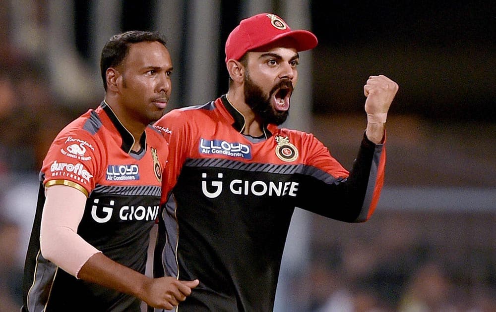 RCB captain Virat Kohli celebrates with bowler S Badree