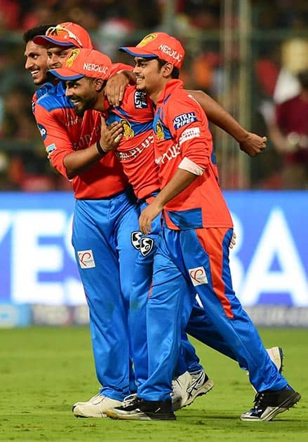 Gujrat Lions Andrew Tye and Basil Thampi celebrates the wicket of Chris Gayle