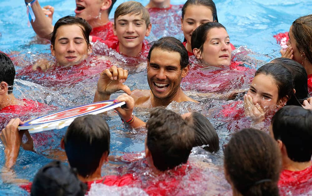 Nadal celebrates inside a swimming pool after winning his men`s finals match