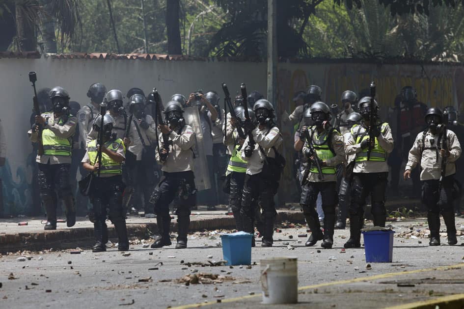 National Police stand ready to launch tear gas National Police stand ready to launch tear gas