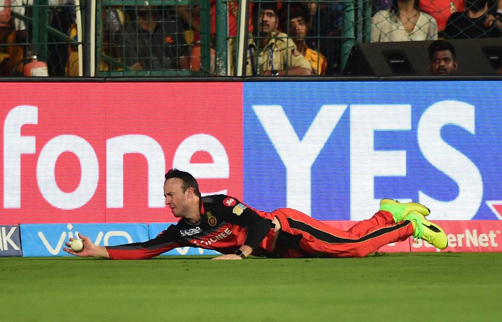 Bangalore AB De Villiers dives to stop the ball