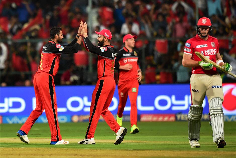 Bangalores Sreenath Aravind with skipper Virat Kohli celebrates