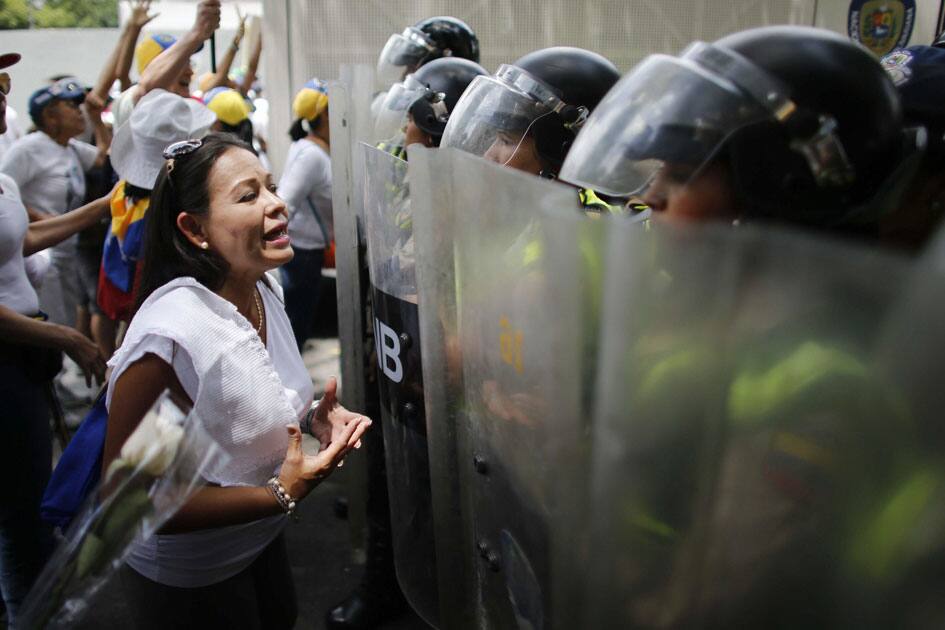 riot police blocking the way of a women riot police blocking the way of a women
