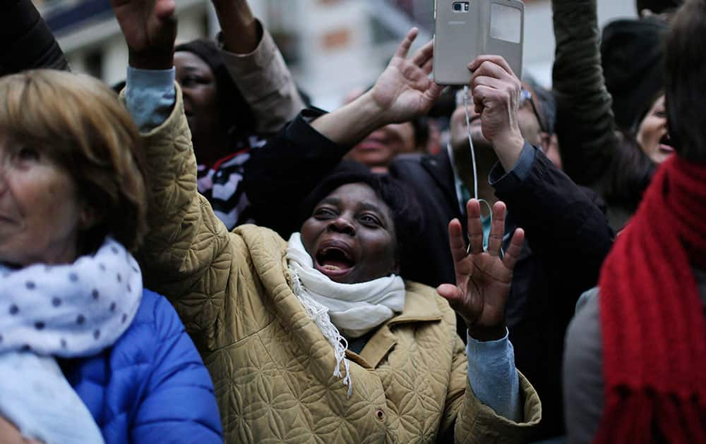 Supporters of Emmanuel Macron react outside his campaign headquarters