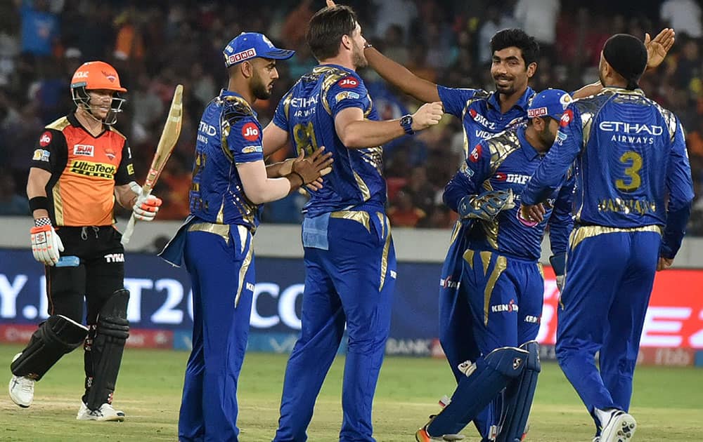 Mumbai Indians cricketers celebrate wicket of DA Warner