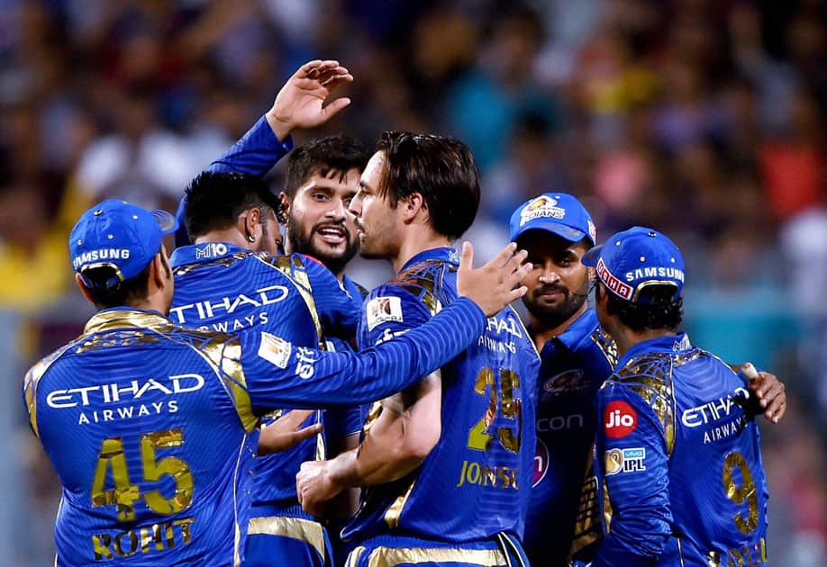 Mumbai Indians players celebrate the dismissal of KKR skipper Gautam Gambhir