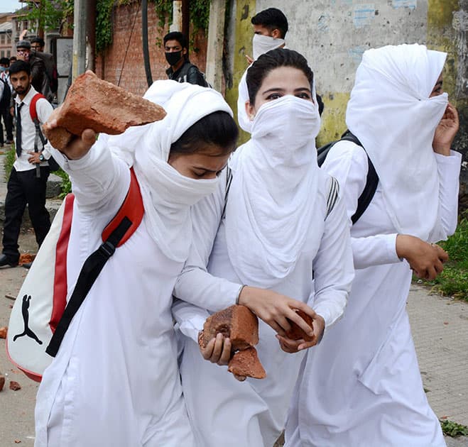 Girl Students holding stones during fresh clashes between students Police