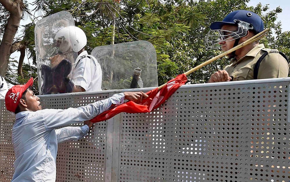 A Left Front activist attacks Murlidhar Sharma, deputy commissioner, STF of the Kolkata Police