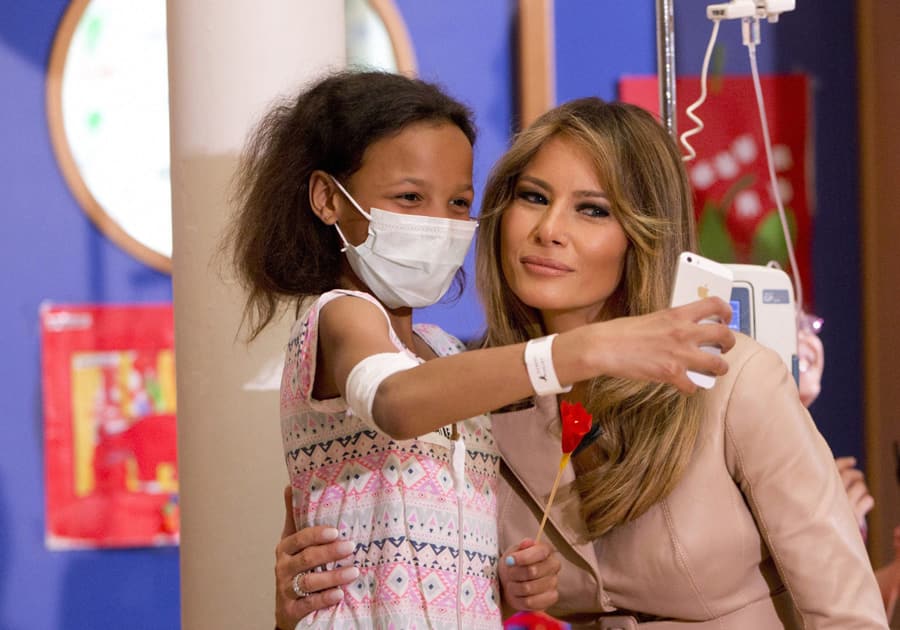 A small child takes a selfie with Melania Trump A small child takes a selfie with Melania Trump