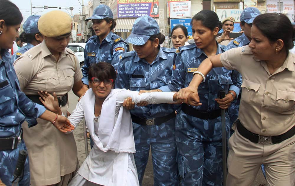 Police women try to remove one of the girls