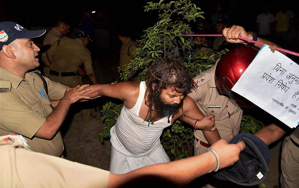 Police take away a follower Swami Shivanand Saraswati