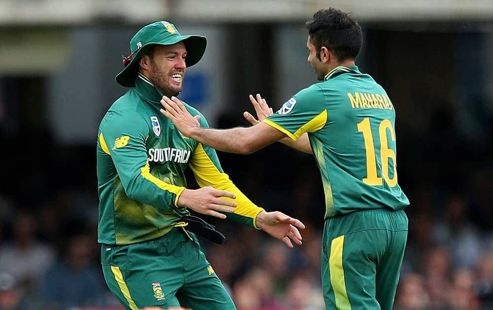 South Africas Keshav Maharaj celebrates with AB de Villiers