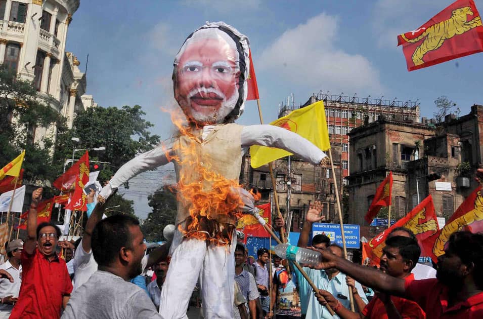 party activists burn effigy of Narendra Modi to protest