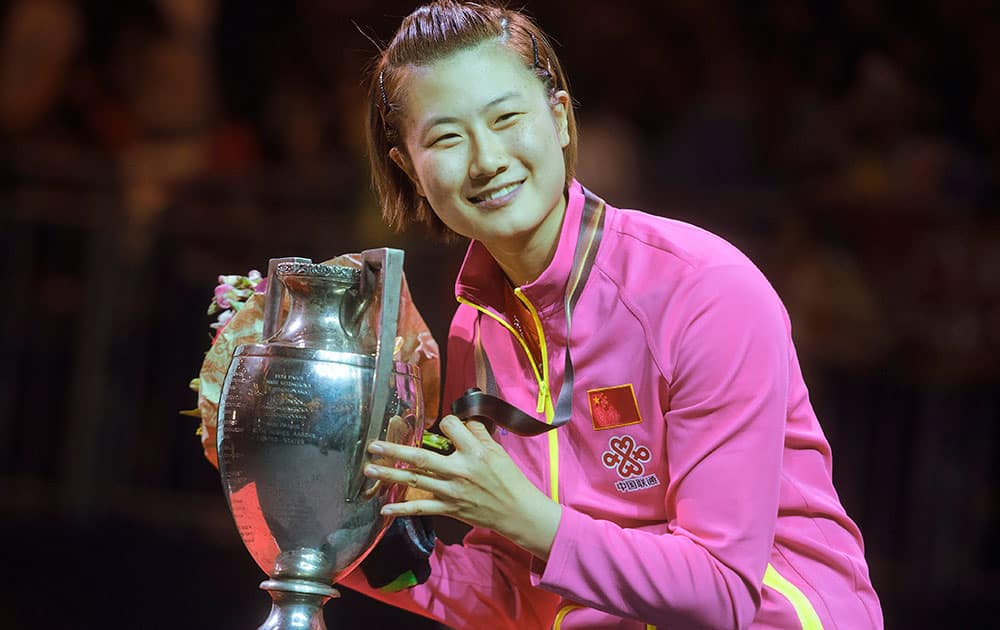 Ding Ning poses with the cup at the victory ceremony