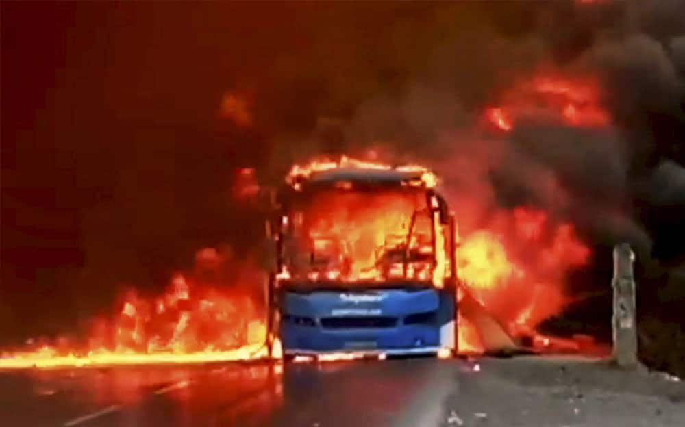 Farmers torch buses