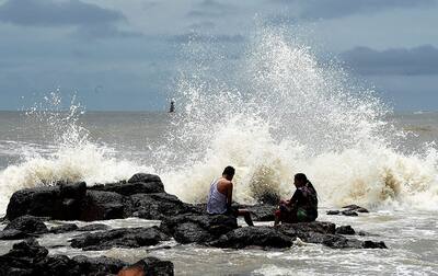 People enjoy the high tide during the monsoon season