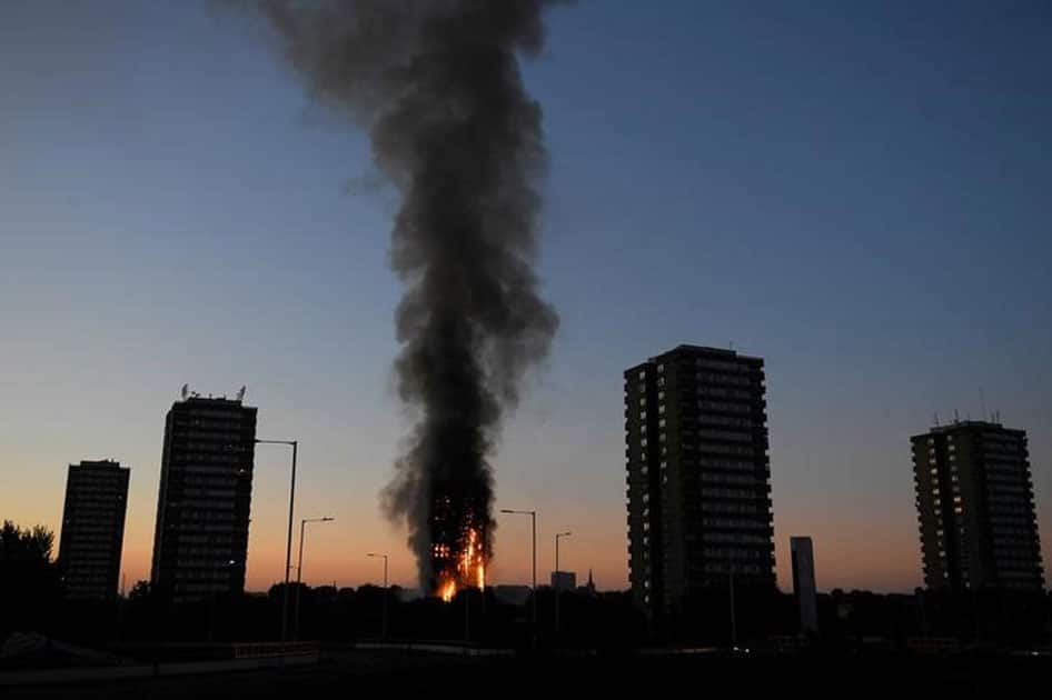 Flames and smoke billow as firefighters deal with a serious fire in a tower