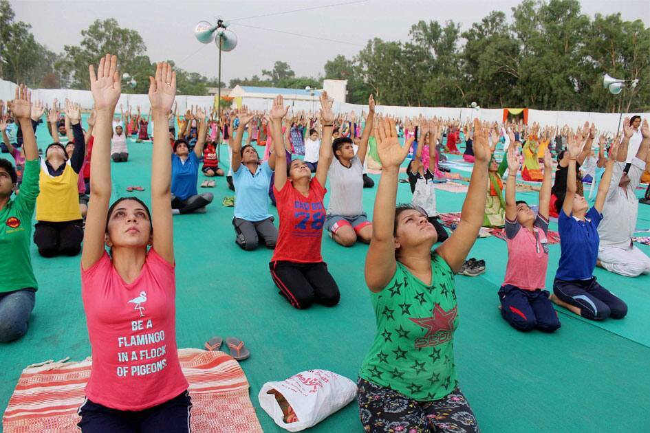 Youths perform yoga at a university